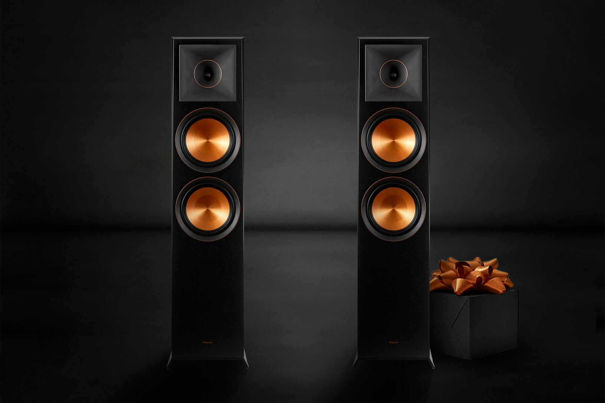 RP 8000 F floorstanding speakers on black with copper bow present